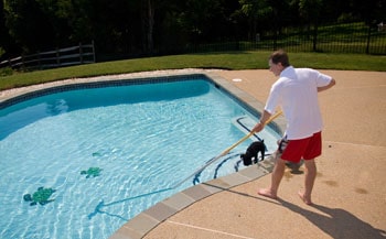 Man with a pool brush.