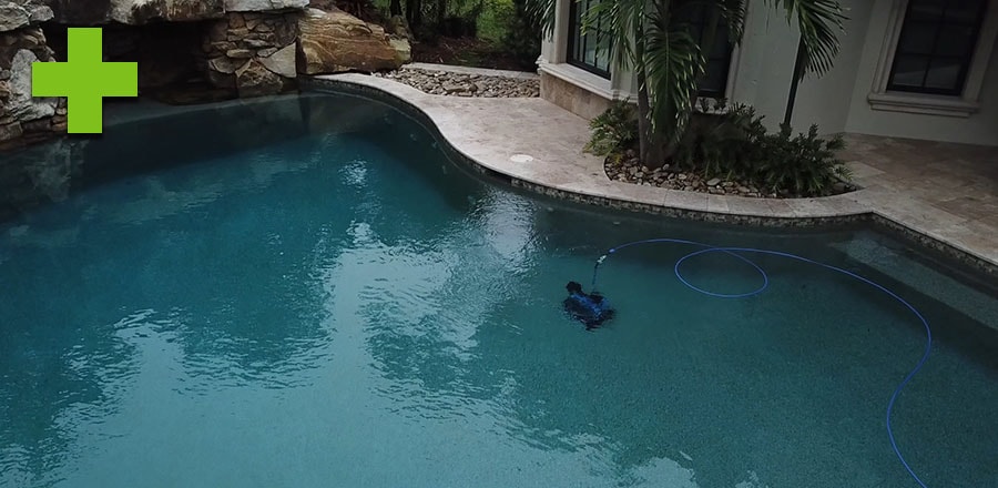 Supreme cleans the bottom of a pool.