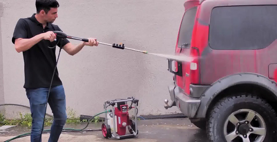 Man washes his car using Briggs&Stratton S2000 electric pressure washer.