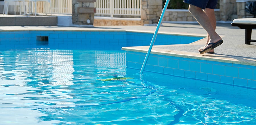 Man cleans the pool.