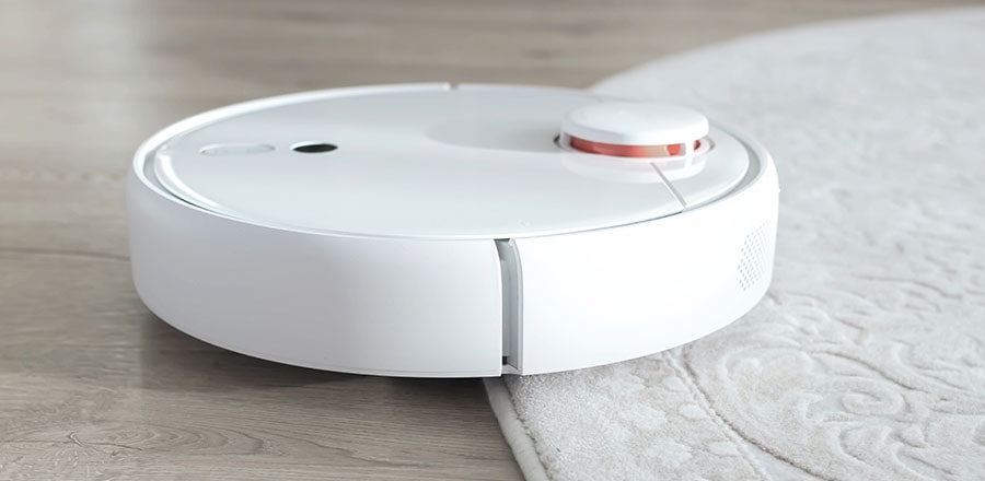 Robot vacuum cleaning a carpet.