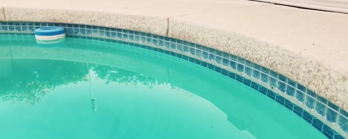 Swimming pool with its tiles covered by calcium deposits.