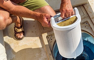 Man installs the cleaned pool filter