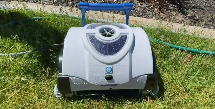 Hayward SharkVac on a yard's grass after it finished the work.