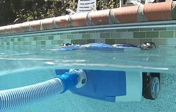 MX8 cleans the waterline of the pool.