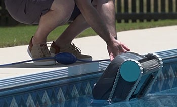 A man dropping Dolphin Advantage into the pool.