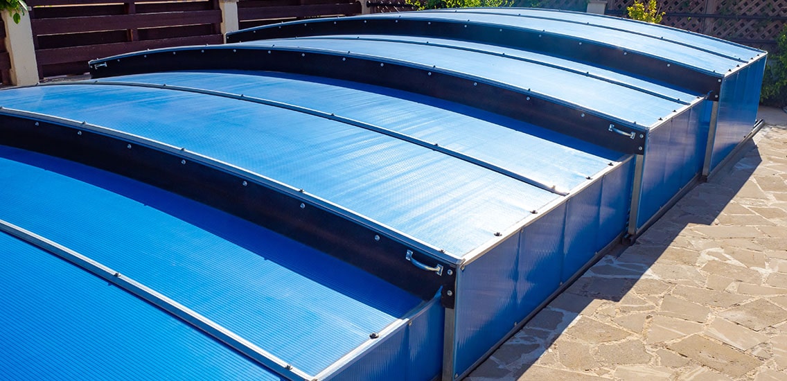 A rigid pool cover covering the pool.