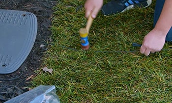 Owner of Husqvarna lawn mower installs the charging station and the boundary wire.