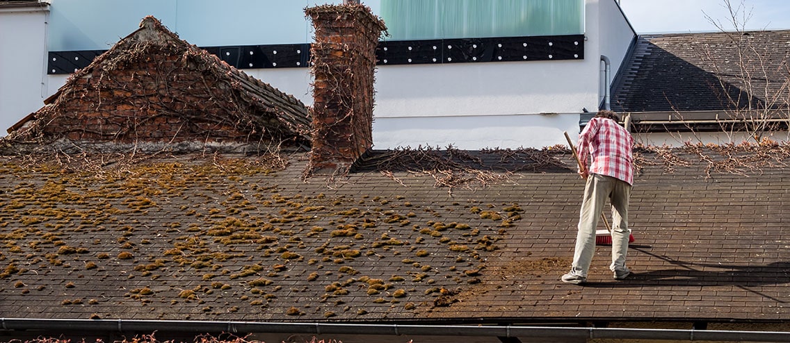 Man sweeps the roof.