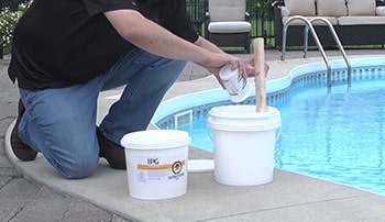Man makes preparations to add calcium-rich chemicals to the water