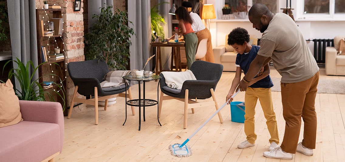 Family cleans the living room.