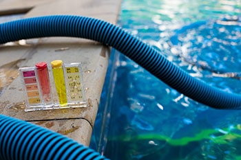 Water test kit, hoses and a swimming pool