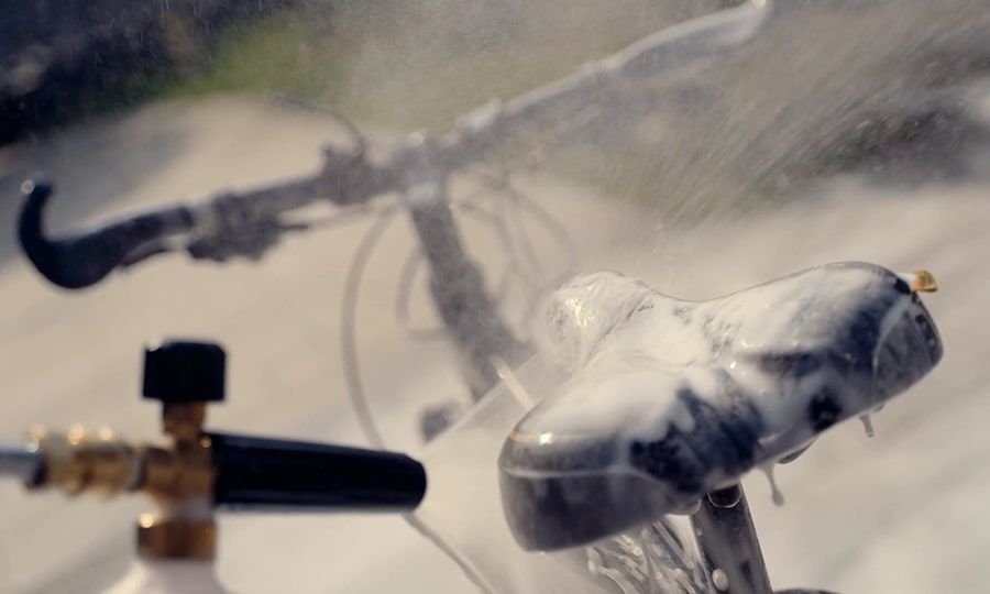 A man washes his bicycle with the help of electric pressure washer from Giraffe.