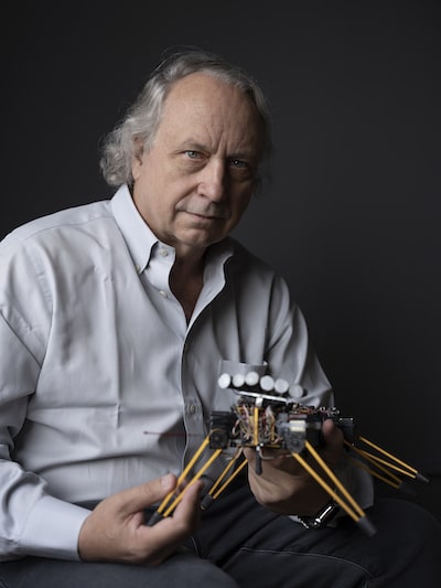 Rodney Brooks, an MIT roboticist is showing a robot